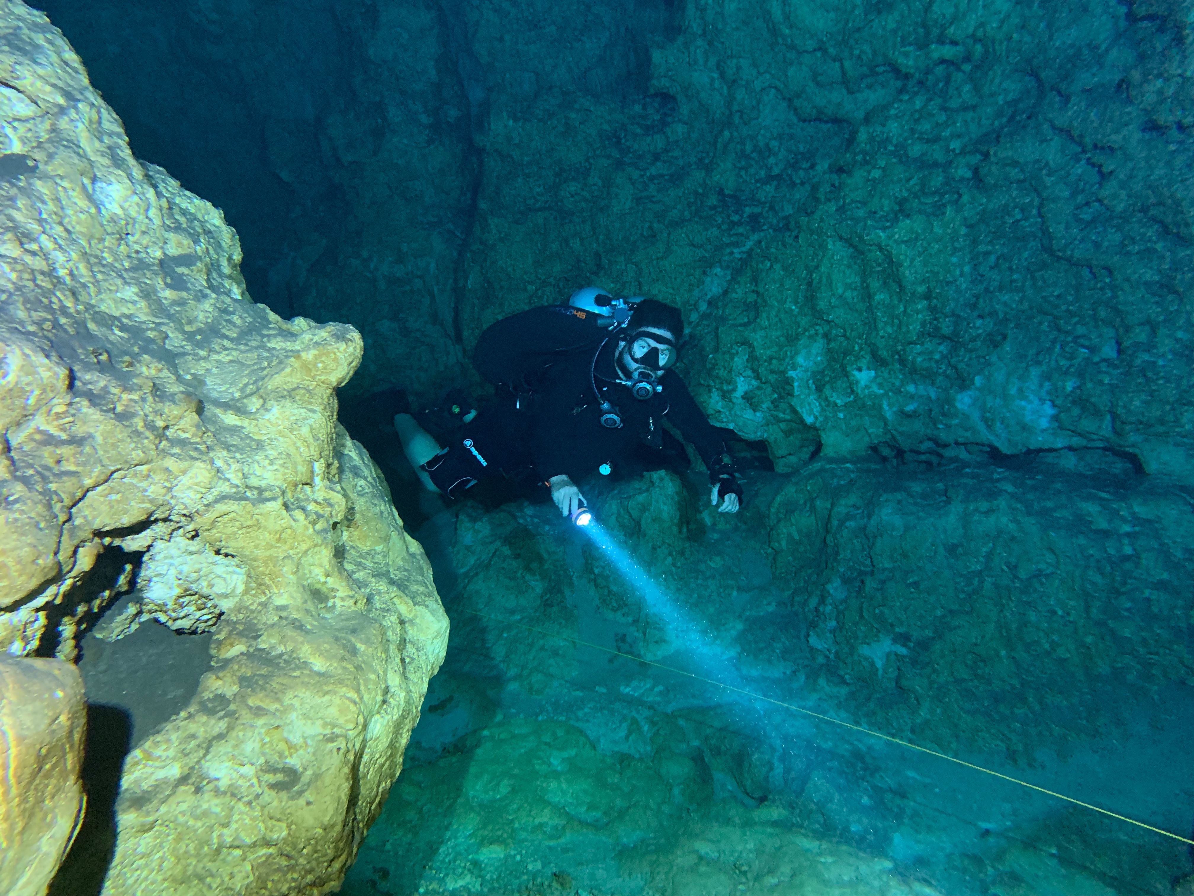 Cave diver in a narrow overhead passage. The mind itself becomes the overhead environment.