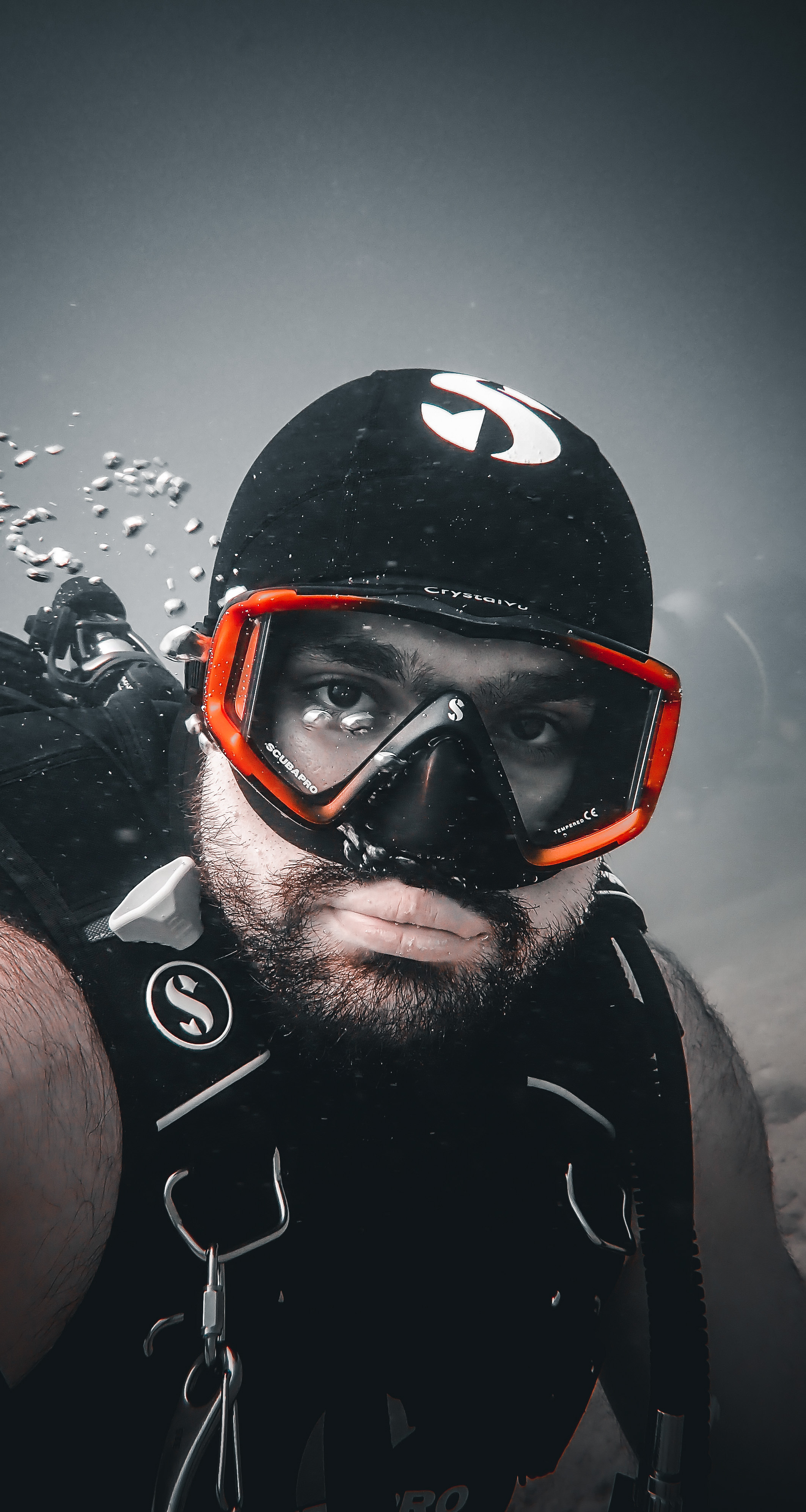 Scuba diver underwater without a regulator in their mouth. The regulator was there. The person holding it was not.